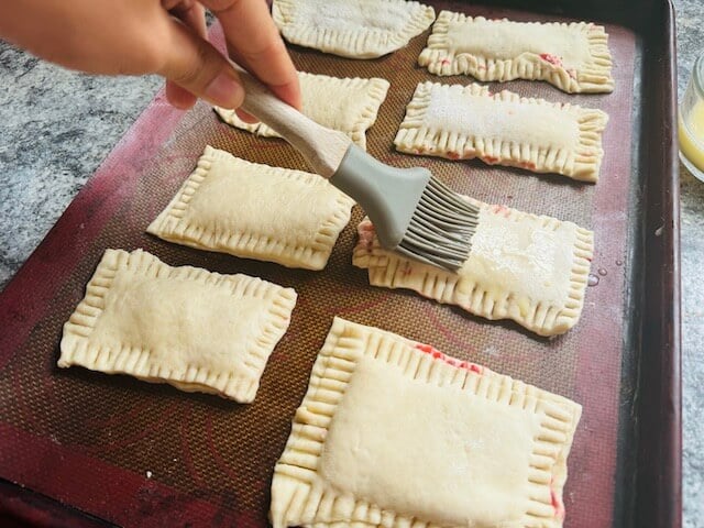 brushing egg wash on Sourdough pop tarts